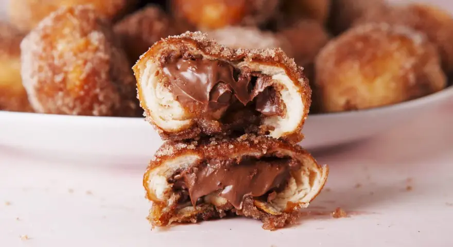 Bretzel au Nutella coupé en deux, révélant une garniture crémeuse au chocolat.