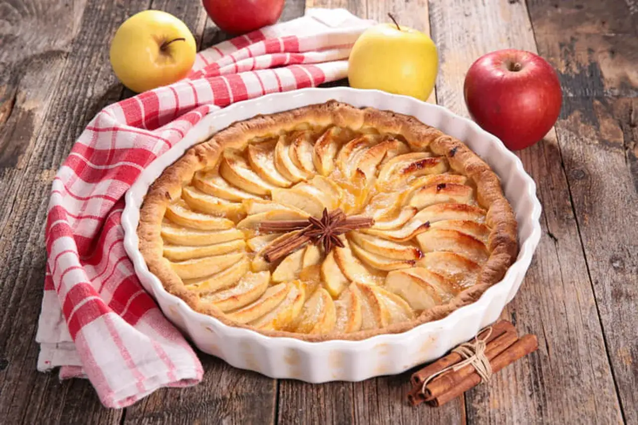 Un d&eacute;licieux appareil tarte aux pommes, orn&eacute; d'une &eacute;toile de badiane et de b&acirc;tons de cannelle, pr&ecirc;t &agrave; &ecirc;tre d&eacute;gust&eacute;.